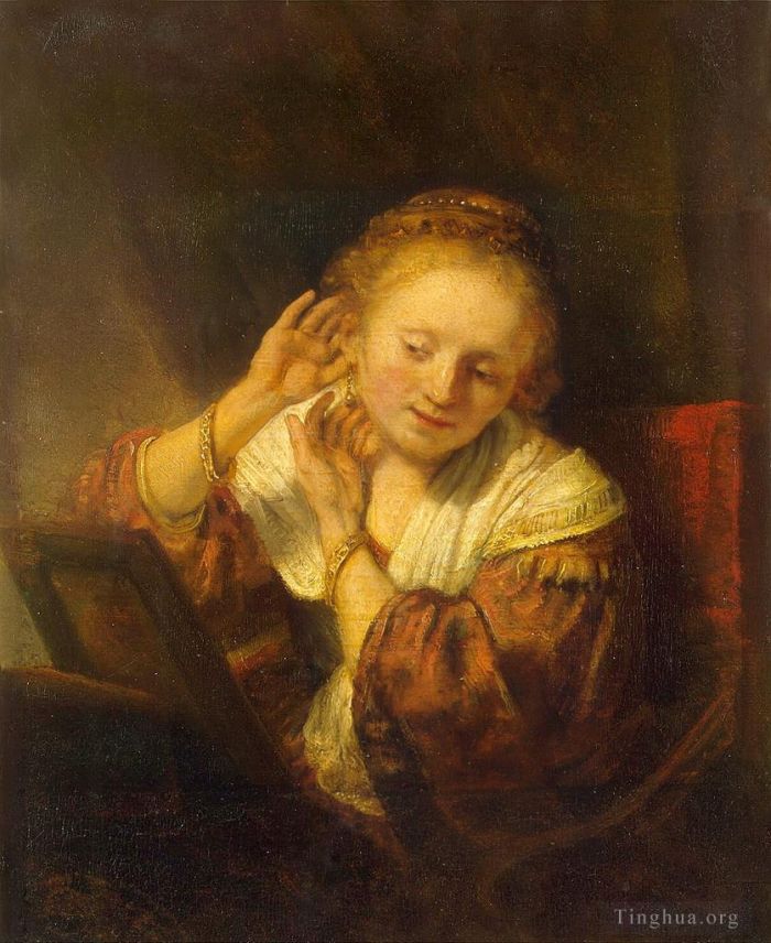 Rembrandt Harmenszoon van Rijn Peinture à l'huile - Jeune femme essayant des boucles d'oreilles
